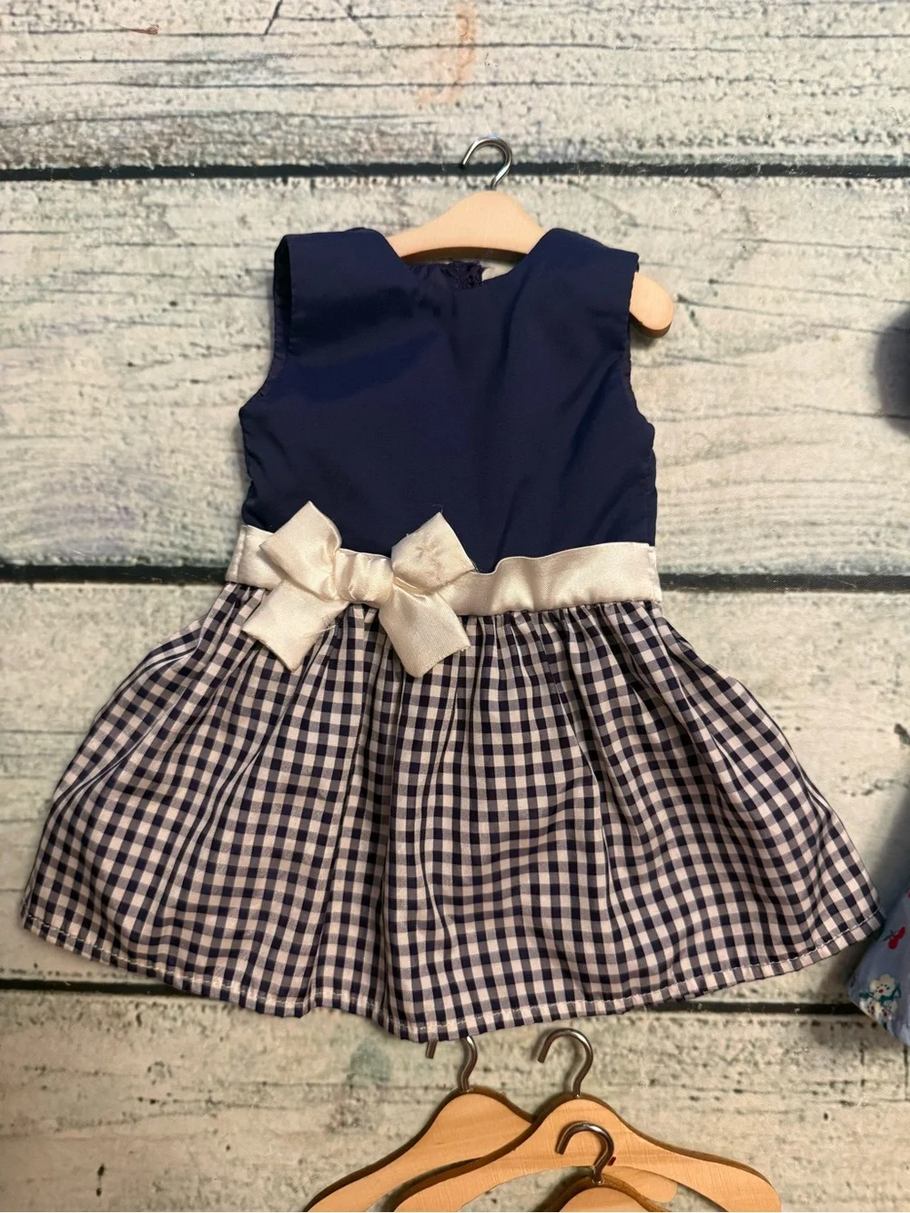 2 American girl doll dresses and 10 wood doll hangers.